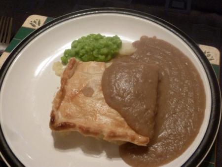 Potato pie with gravy and cream peas