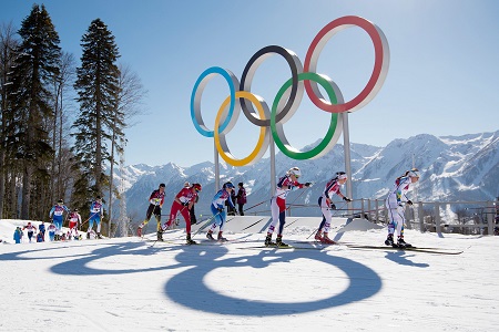 De kopgroep passeert de olympische ringen tijdens de skiathlon voor dames (PRO SHOTS/Witters)