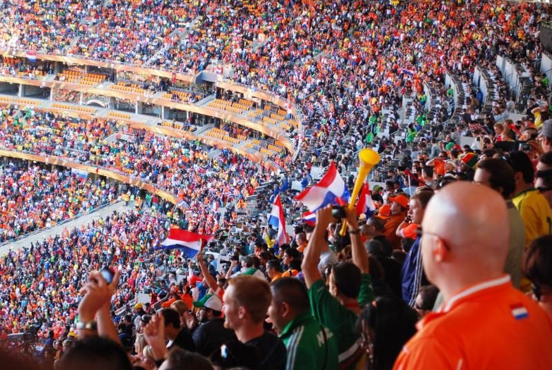 Fans Cheer During The Netherlands vs. Denmark Soccer Match 2010 (@WikimediaCommons) Fans Cheer During The Netherlands vs. Denmark Soccer Match 2010 (@WikimediaCommons)