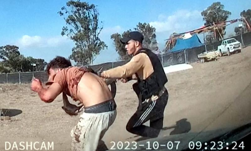 Hamas militant kidnapping an Israeli civilian at the Supernova festival (@Dashcam footage: No human authorship)