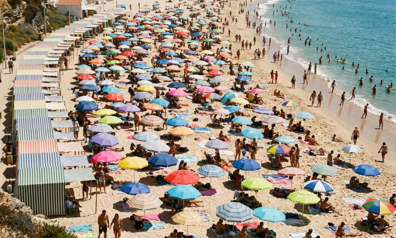 Portugees strand vol met parasols (@Gemini-AI-impressie) 